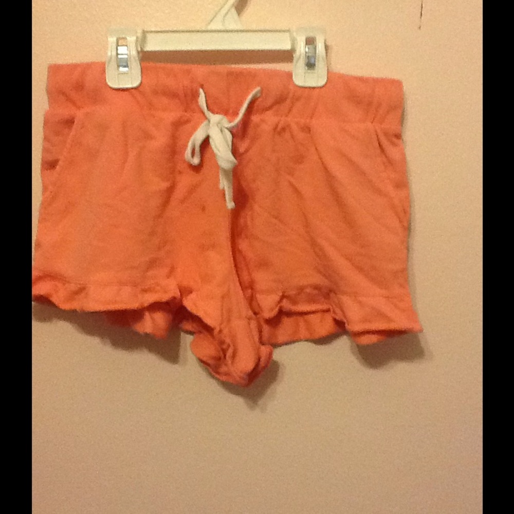 Coral shorts with ruffle trim