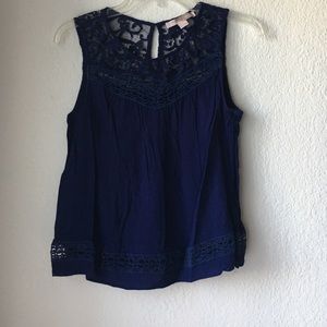 Blue sleeveless top.
