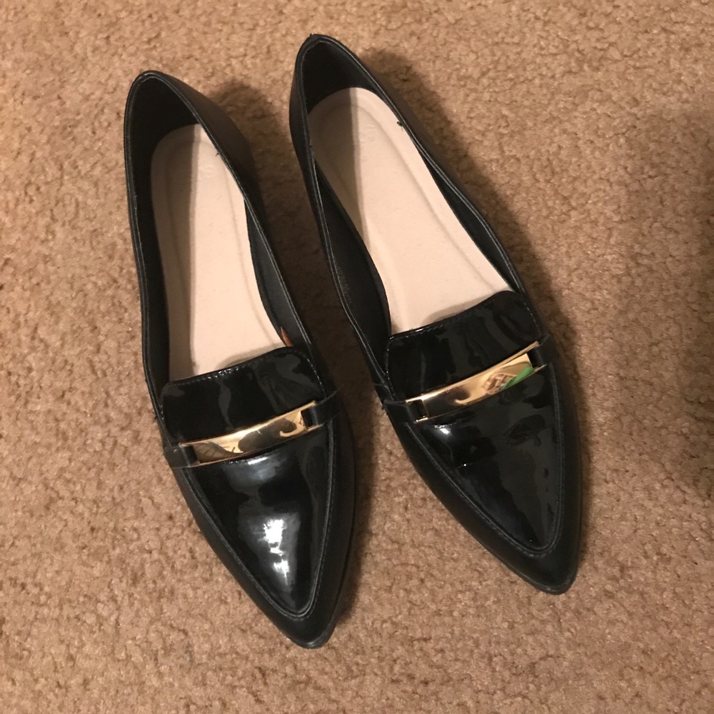 Black loafers with gold detail