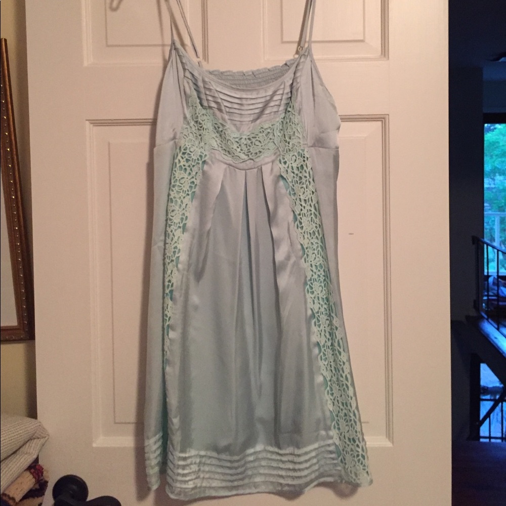 A silk with lace inserts. Adjustable straps