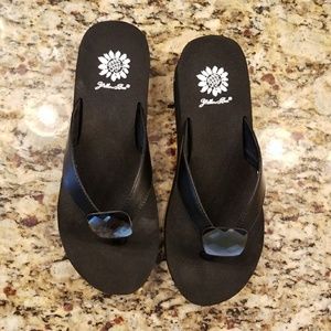 Black yellow box flip flops.