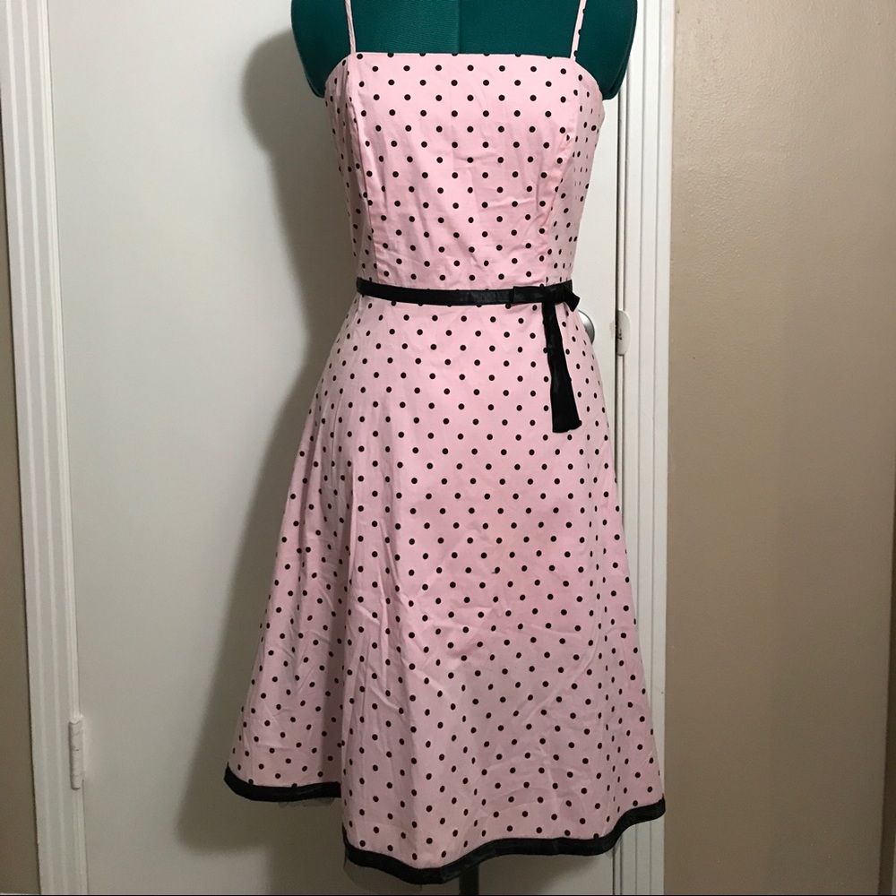 Pink dress with black polka dots.