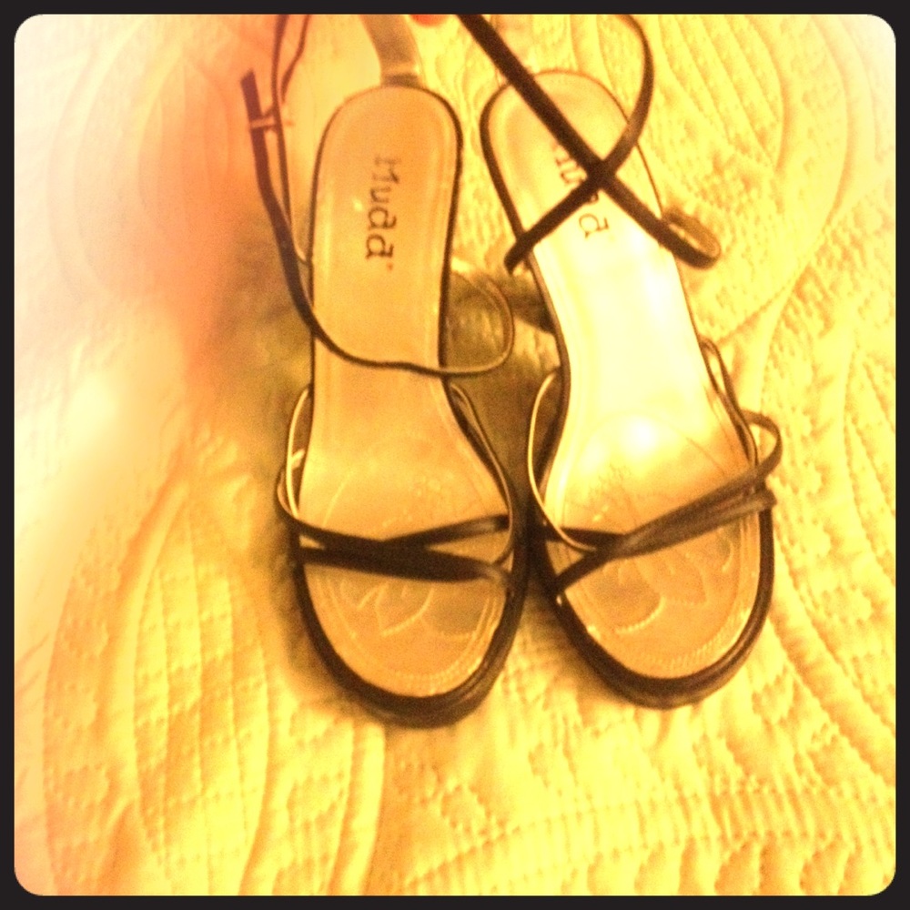 Well worn high heels with straps.