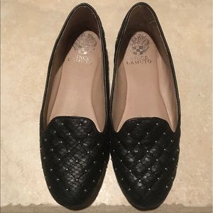 Black loafers with small metal studs on quilting