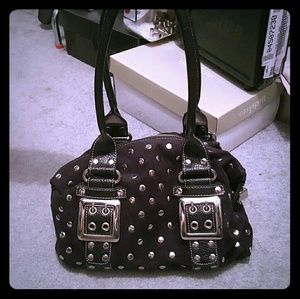 Studded bag with adjustable buckles
