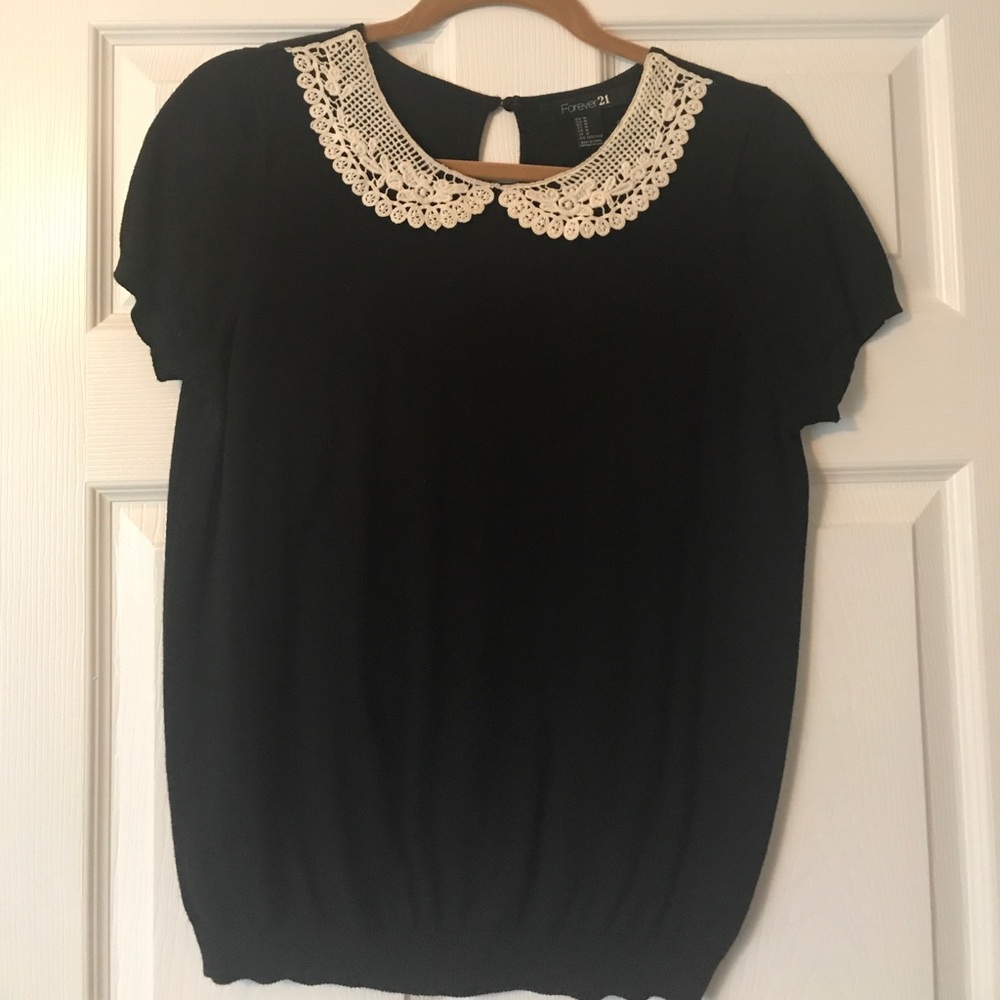 Black top with white collar detail.