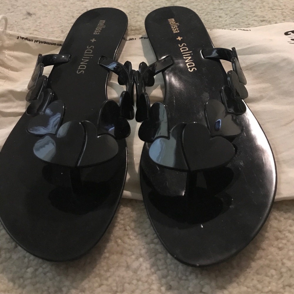 Black, fancy-ish flip flops.