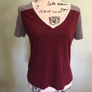 Maroon, grey and white women's v-neck shirt.