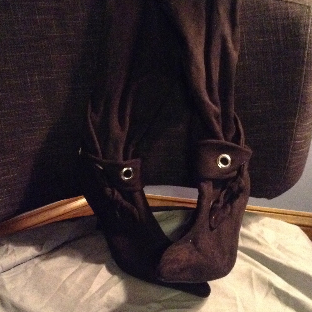 Tall suede black boots with silver designs.