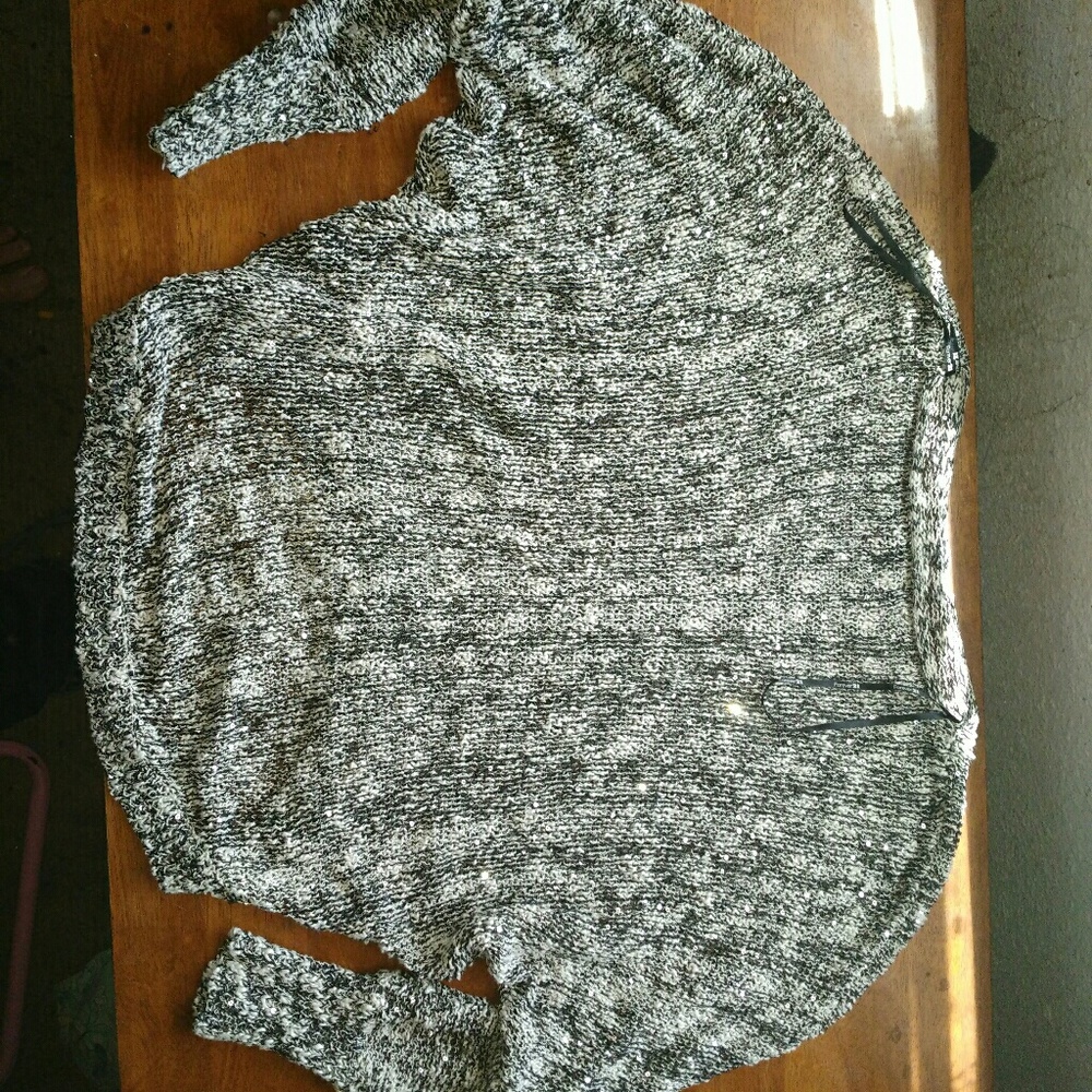 A sequence black and white long sleeve sweater