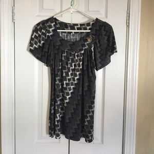 Unique, flattering top with button detail