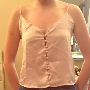A light pink Brandy Melville button up tank top