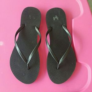 Black sandals, worn, in descent condition.