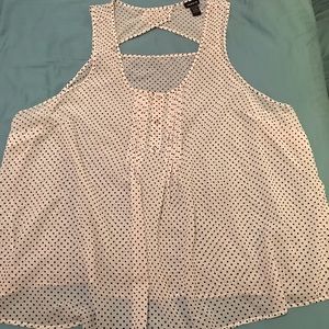 White sleeveless blouse with black polka dot