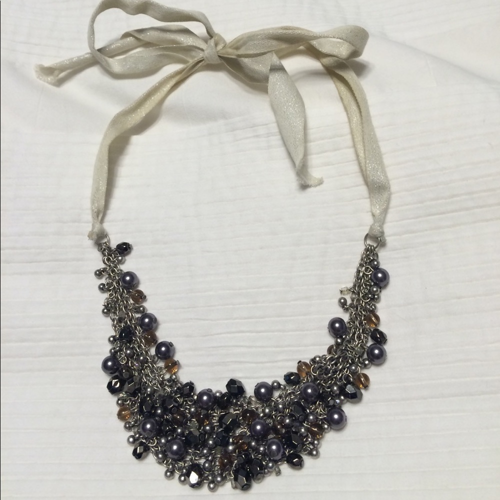 Beaded necklace with ribbon sides and tie closure