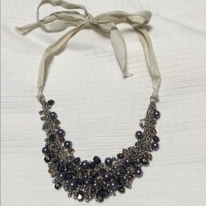Beaded necklace with ribbon sides and tie closure