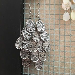 Metal drop earrings with small black stones