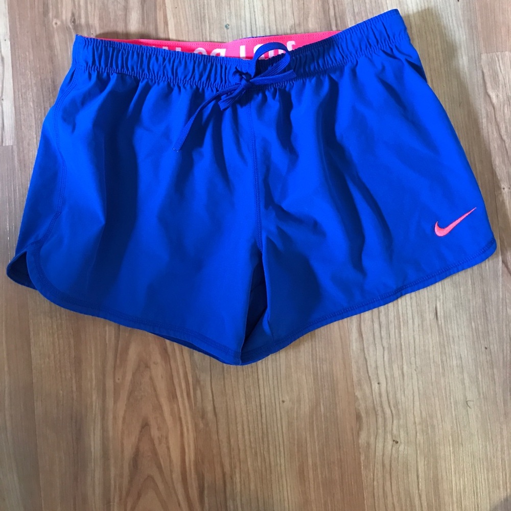Blue nike running shorts with hot pink lining.