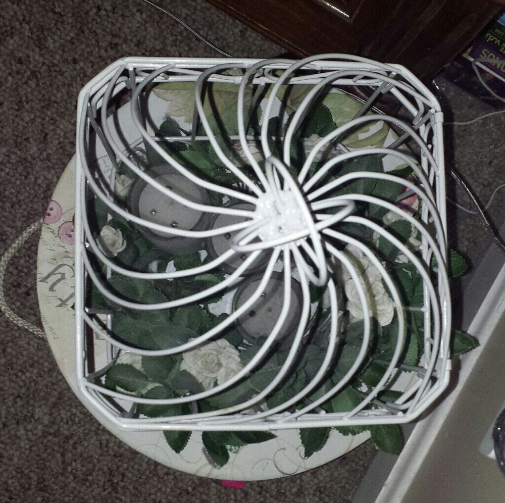 White Bird cage with candles and flower vines.