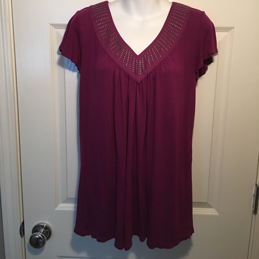 Cute top with neckline embellishments.