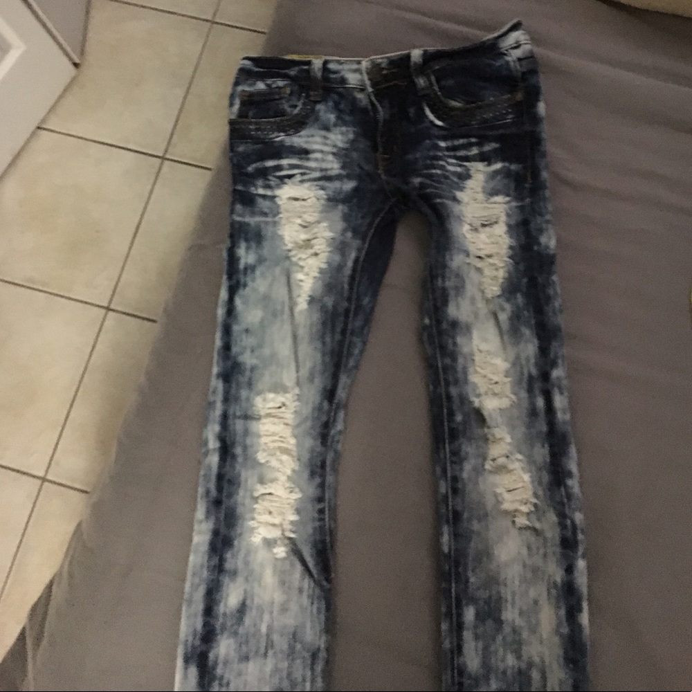 Machine distressed tye dye denim jeans