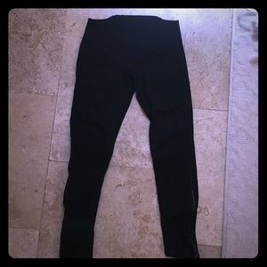 Black leggings with zippers down the bottom sides