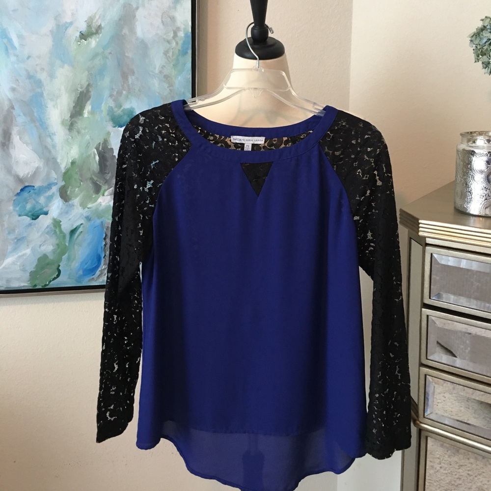 Royal blue blouse with black lace sleeves.