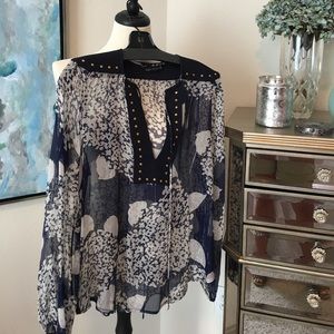 Sheer print blouse with gold accents.