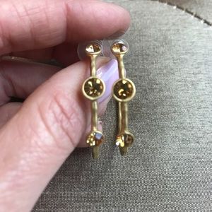 Gold hoop earrings with three yellow stones