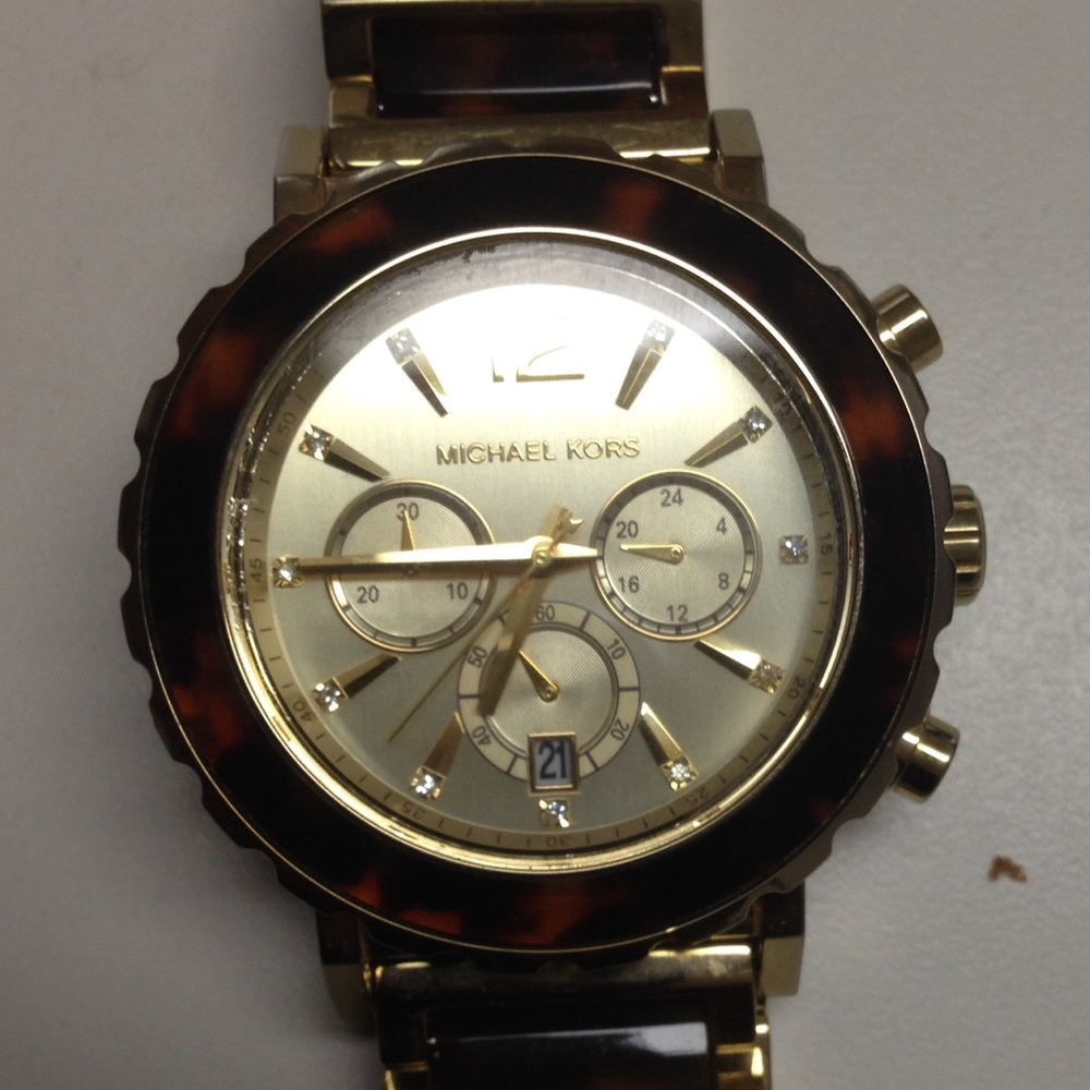 Gold and woodgrain Mickael Kors watch.
