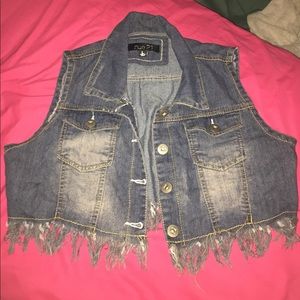 Blue jean vest with fringes.