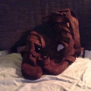 Brown suede strapped boots.