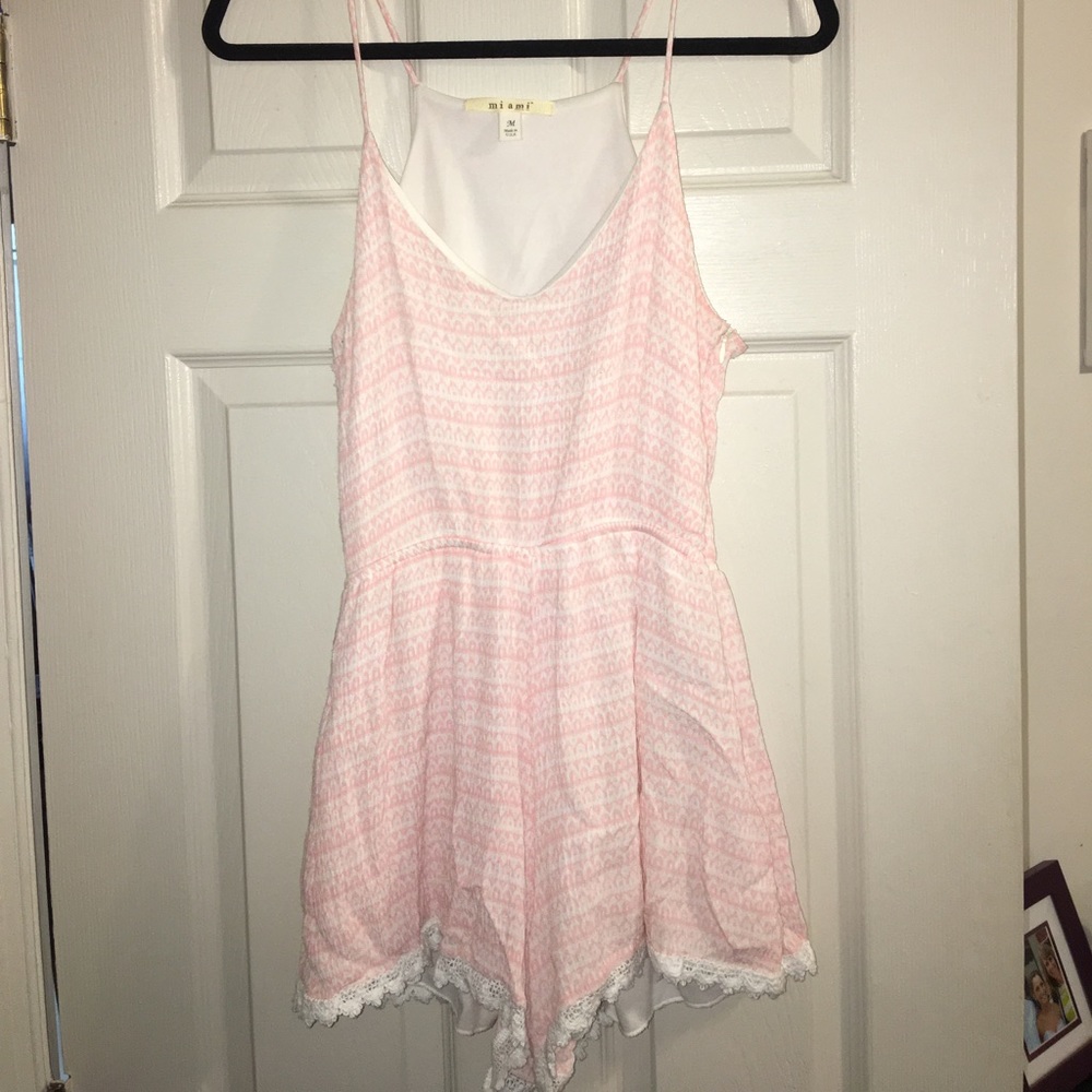 Pink romper with lace trim on bottom