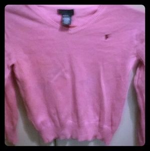 A pink polo sweater