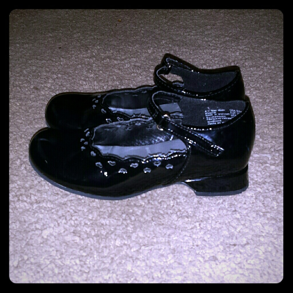 Black shiny dress shoes with cut out hearts