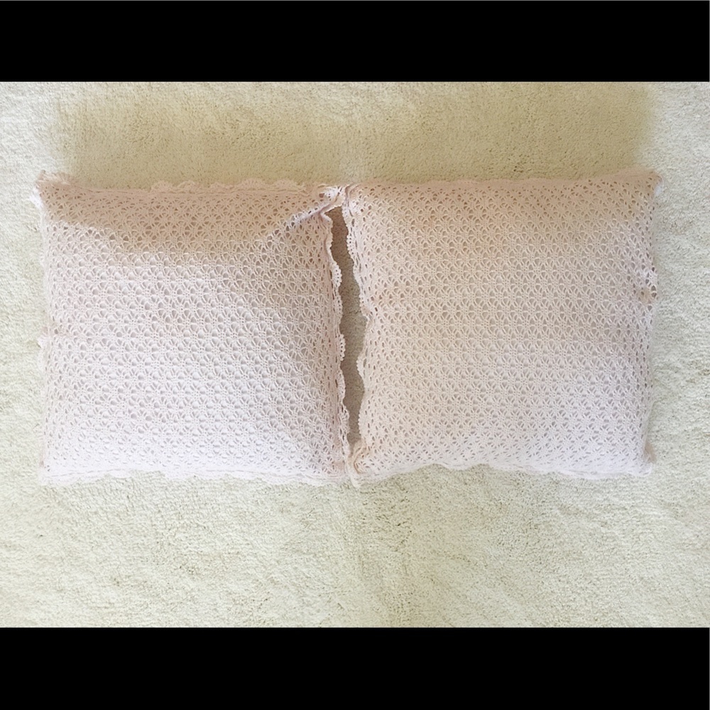 A set of two pale pink throw pillows