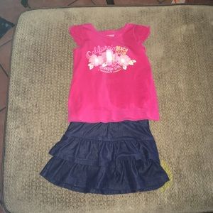 A set of a pink shirt and navy blue skirt