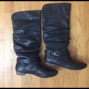 Tall black slouchy faux leather boots with buckle