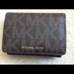 MK trifold wallet. Brand new with tag and booklet.