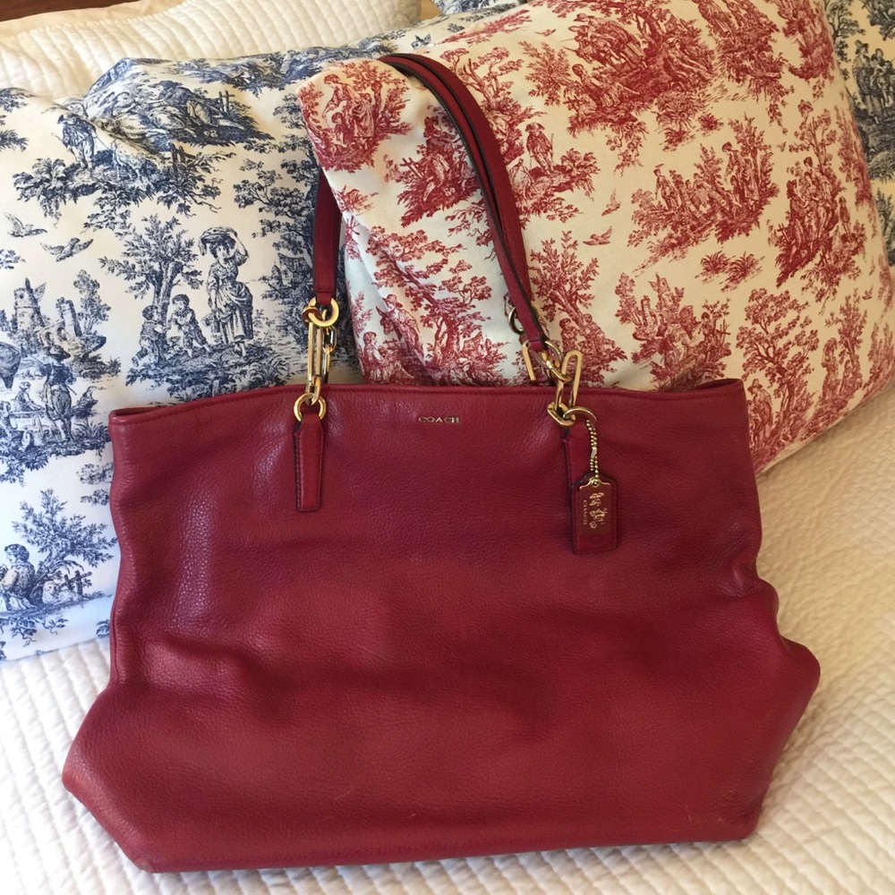 Coach tote in a red wine color with gold hardware