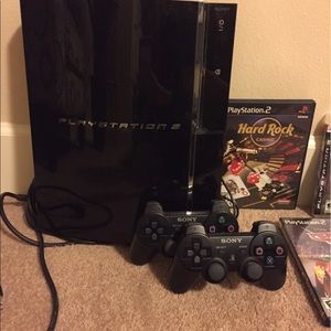PlayStation 3 with wireless remotes and games