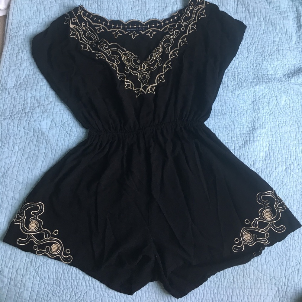 Black romper with featuring gold accents