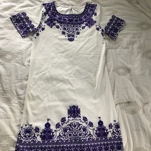 White dress with purple pattern/detail.