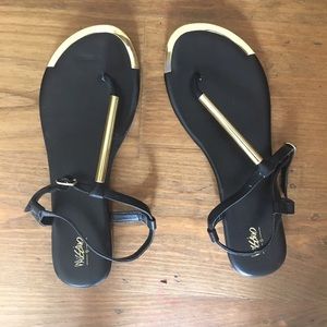 Black sandals with gold detail