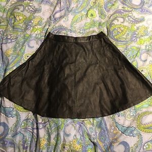 Black pleather circle skirt.