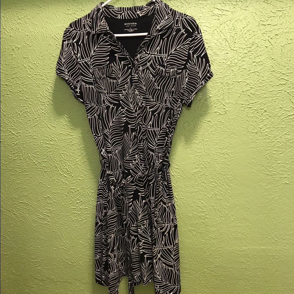 Black shirt dress with white floral print & belt.