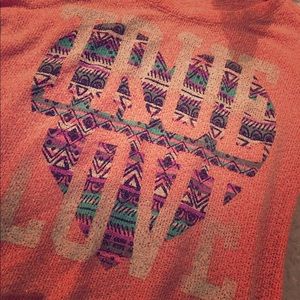 Salmon pink top with graphic design