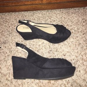 Wedge black velvet material open toe heels.