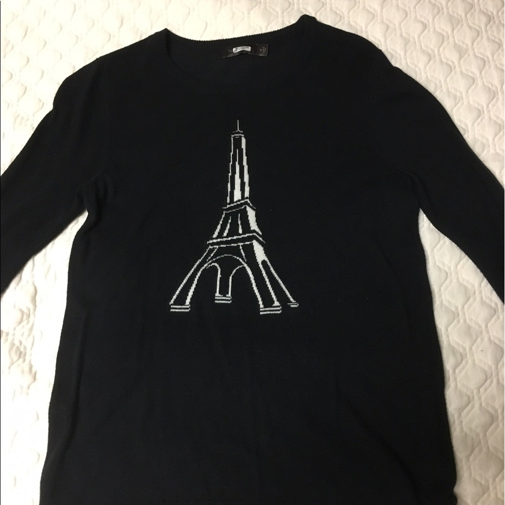 Black sweater with white Eiffel Tower on front