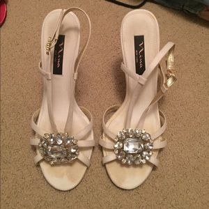 cream strappy heels with large gem embellishment